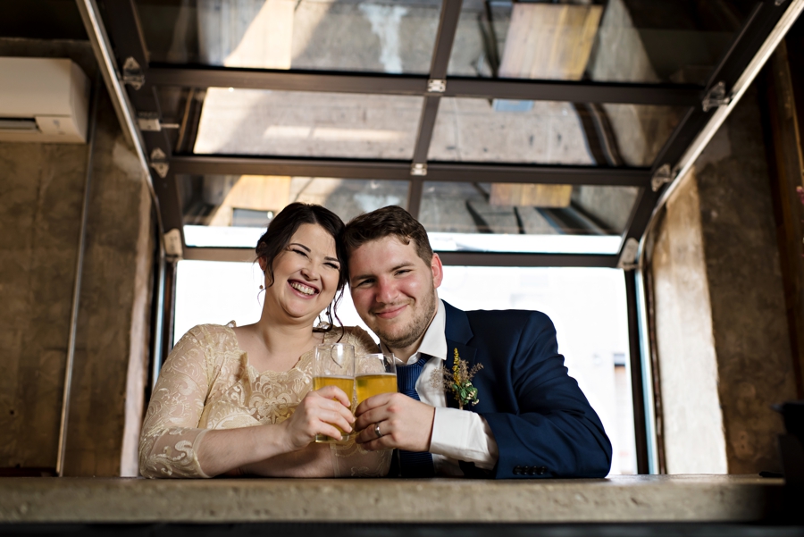 A newly married couple share a beer at the bar after their ceremony in South Philadelphia.